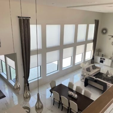 Clean and crisp white rollers add light control without taking away from a minimalist design